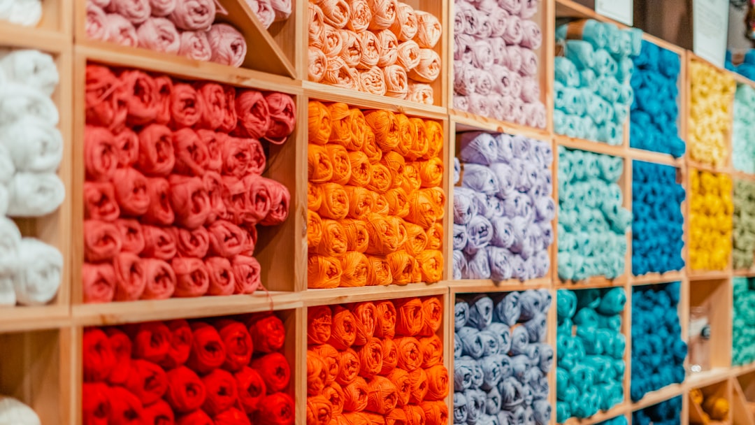 a display of different colored yarns in a store