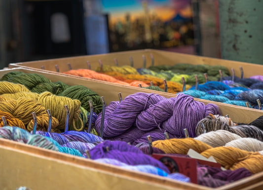 A box filled with lots of different colored yarn