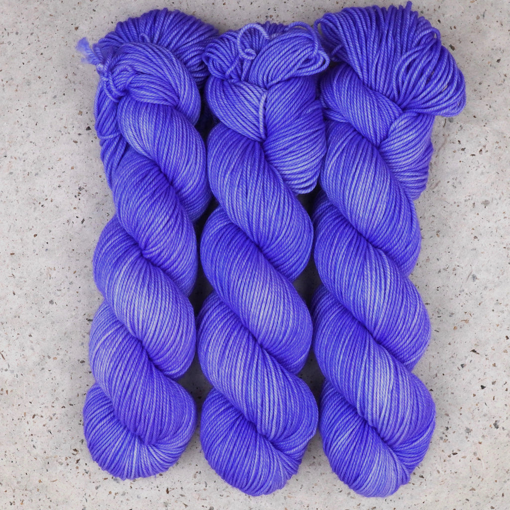 Wild Woollys Crocus Pocus DK yarn, three skeins in periwinkle and violet purple