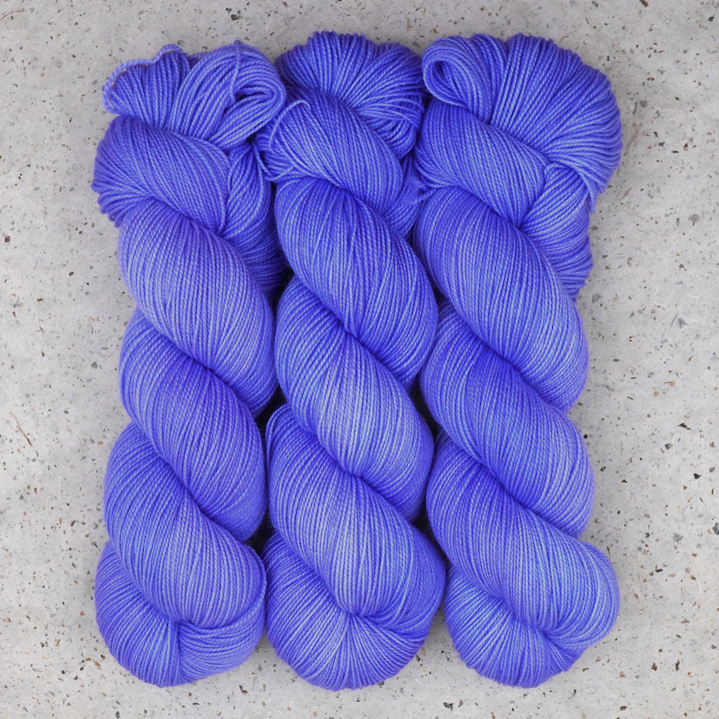 Wild Woollys Crocus Pocus Fingering yarn, three skeins in periwinkle and violet purple