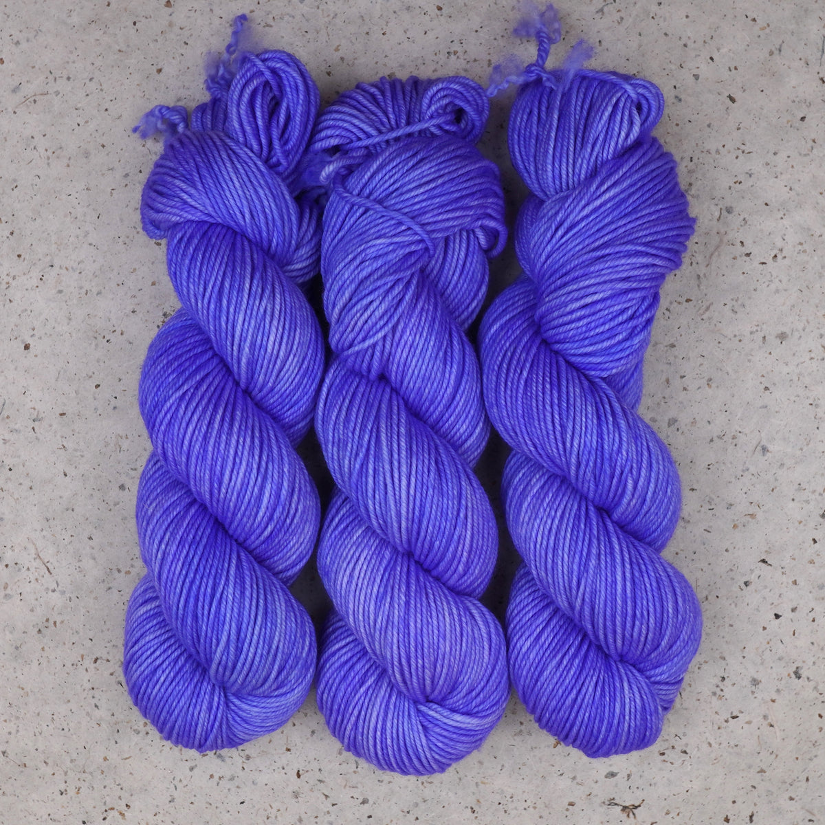 Wild Woollys Crocus Pocus Worsted yarn, three skeins in periwinkle and violet purple