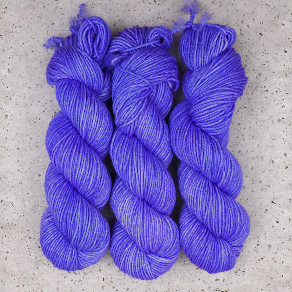 Wild Woollys Crocus Pocus Worsted yarn, three skeins in periwinkle and violet purple