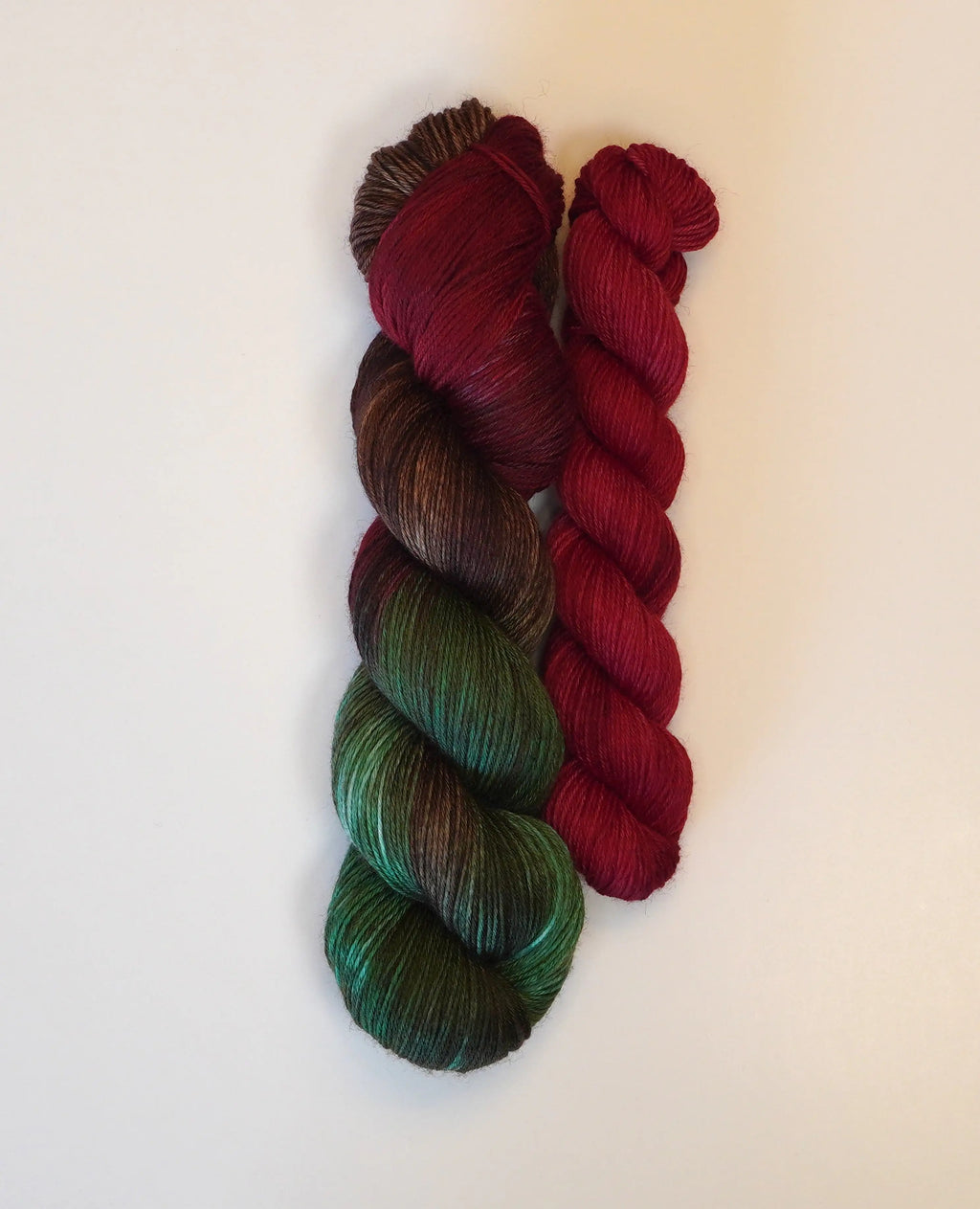 Wild Woollys Woodland Christmas Fingering Sock Set with one variegated skein and one solid red skein