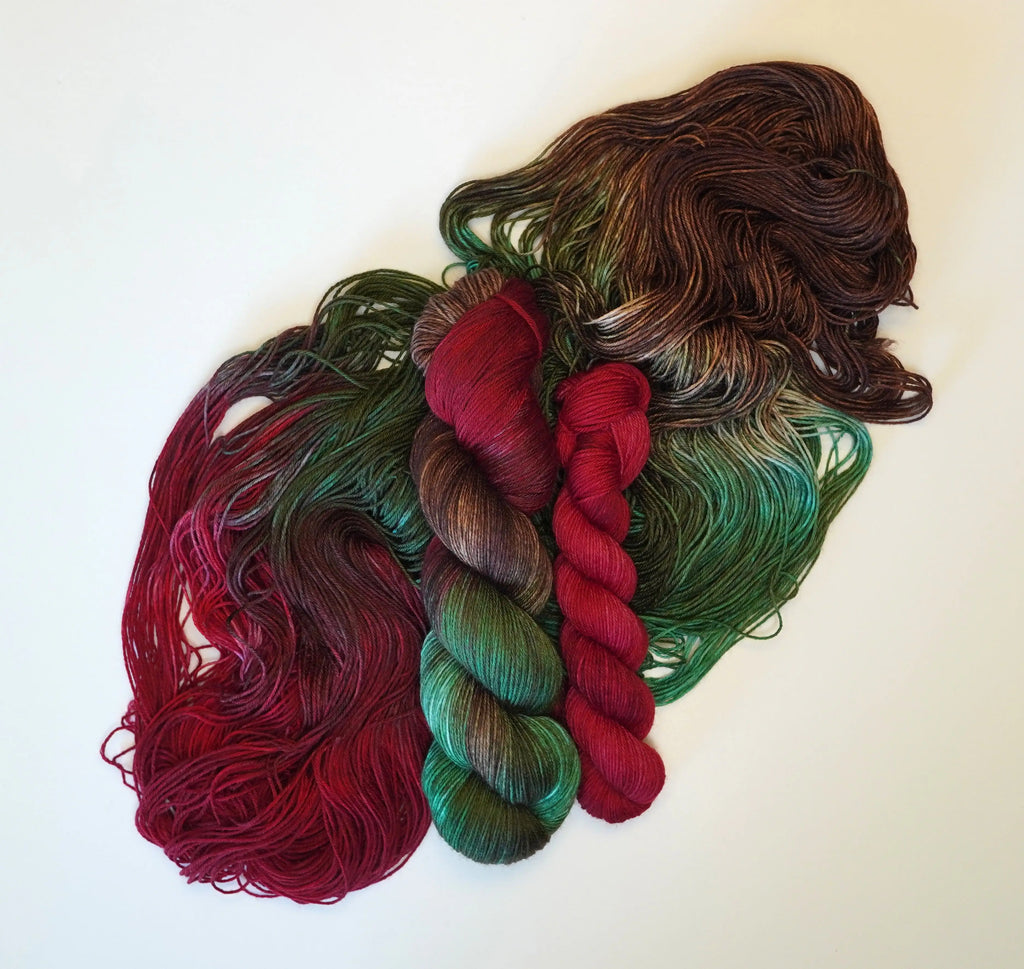 Wild Woollys Woodland Christmas Fingering Sock Set with red, green, and brown yarn