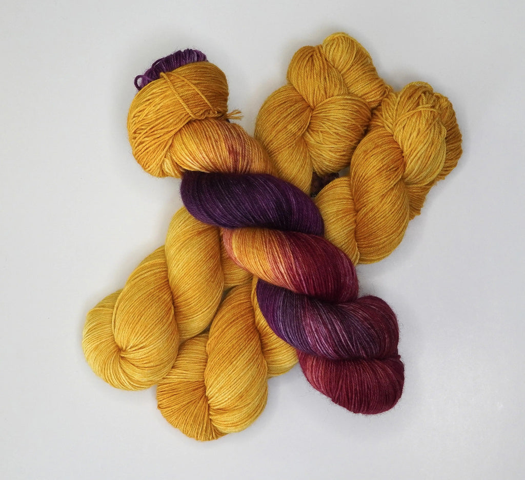 Wild Woollys Hayday yarn in gold, purple, and burgundy