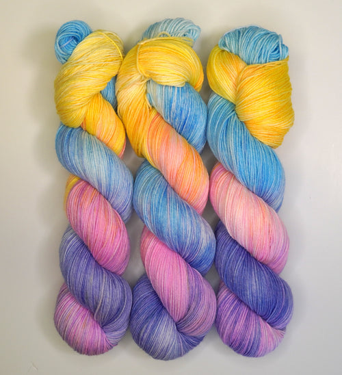 Wild Woollys Fantasy yarn in blue, yellow, orange, pink, and purple