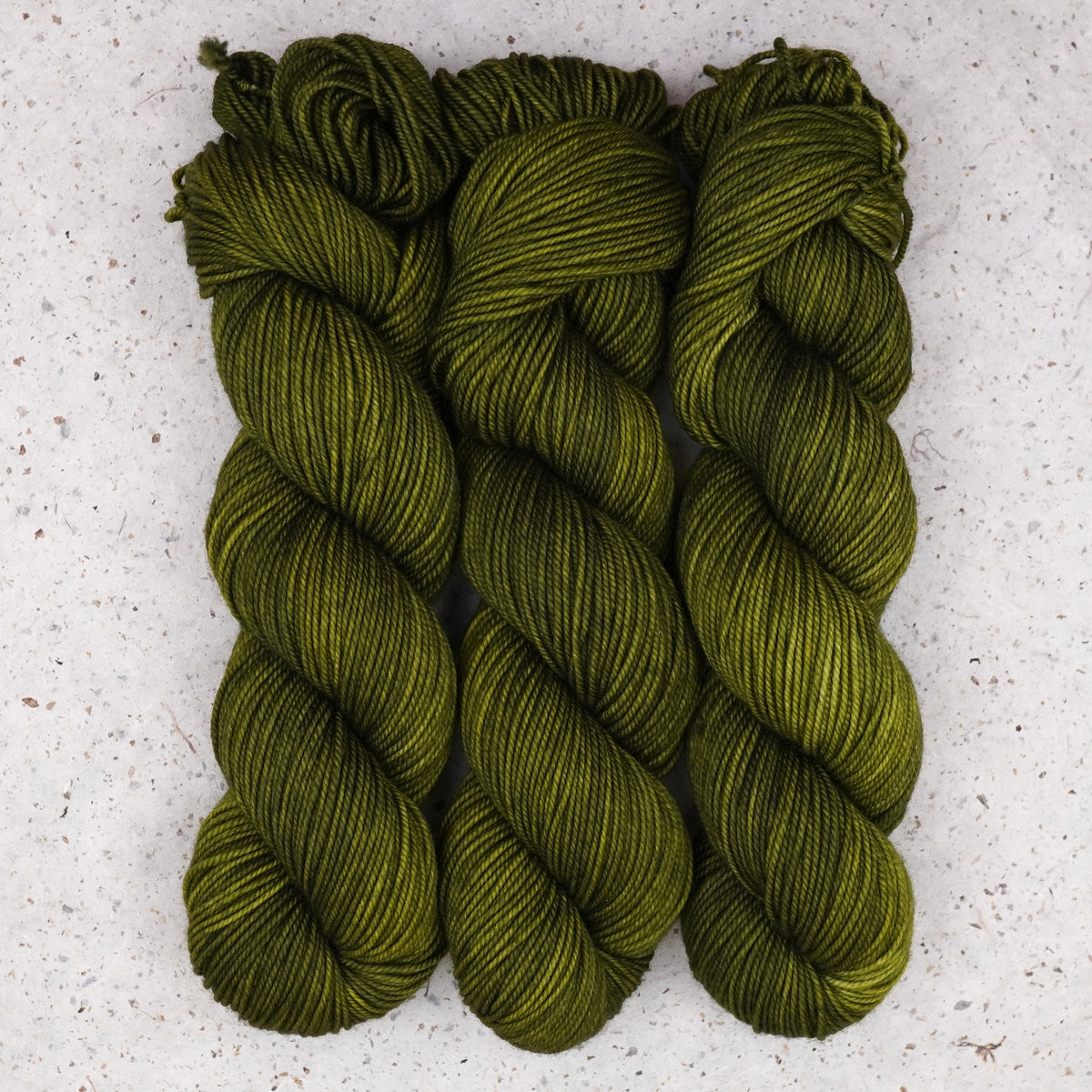 Wild Woollys Fiddlehead Fern DK yarn, three skeins in deep olive green