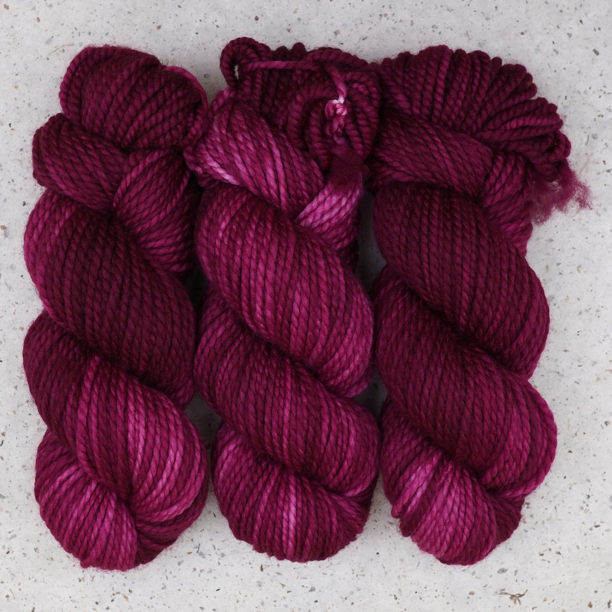 Wild Woollys Fuchsia Nostalgia Bulky yarn, three skeins in deep magenta and berry pink