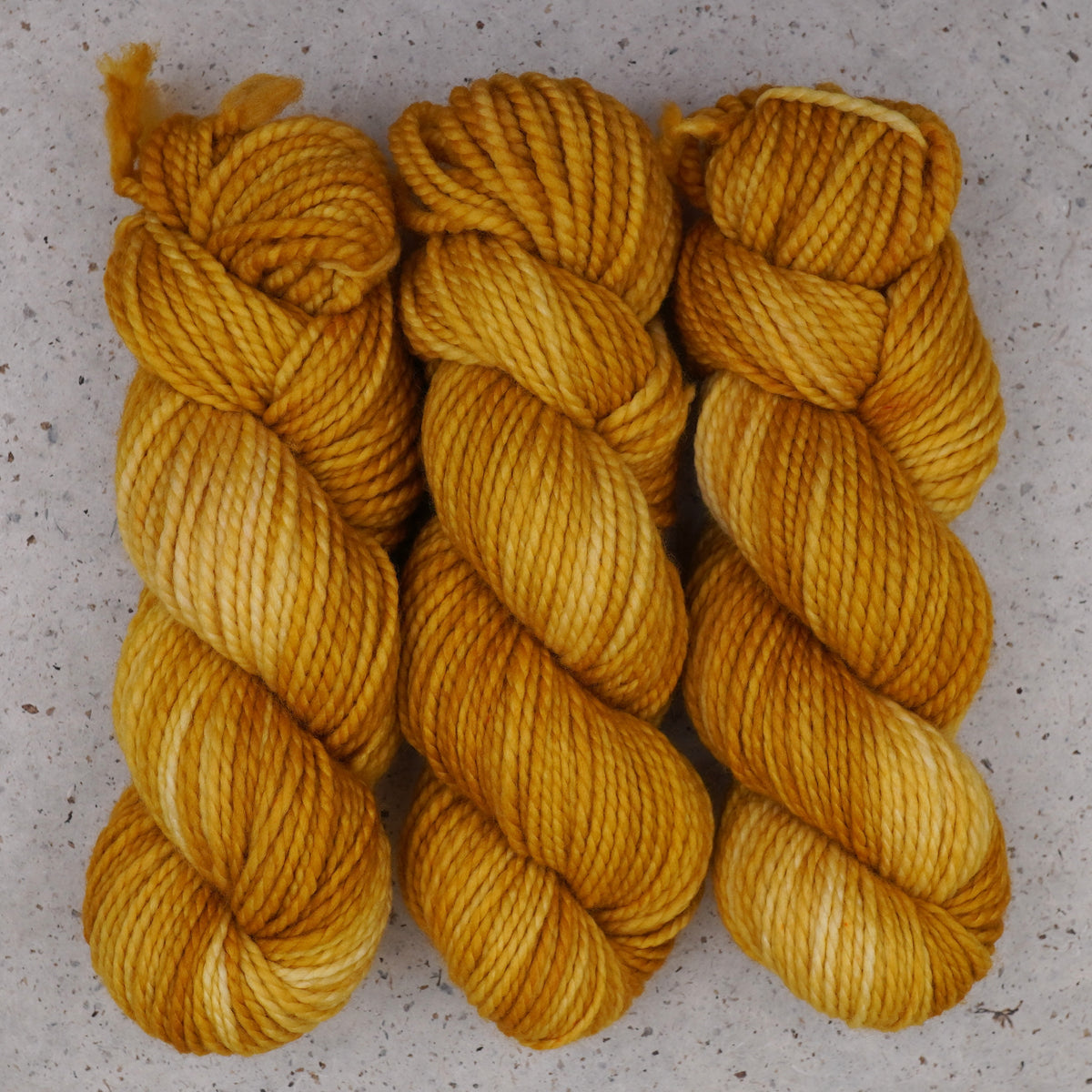 Wild Woollys Hayday Bulky yarn, three skeins in golden yellow and warm amber