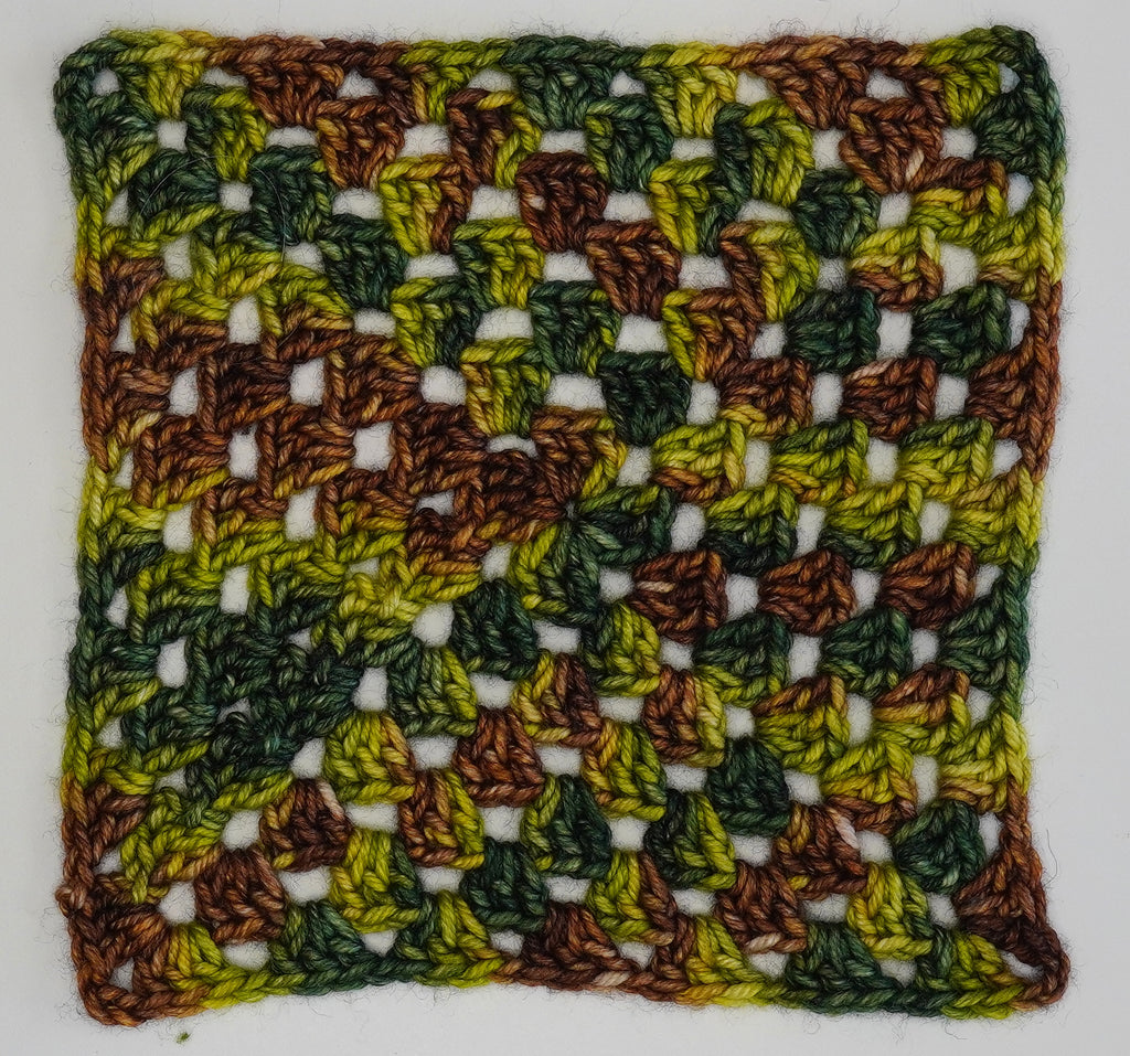 Wild Woollys Jungle Juice yarn swatch with green, brown, and yellow colors