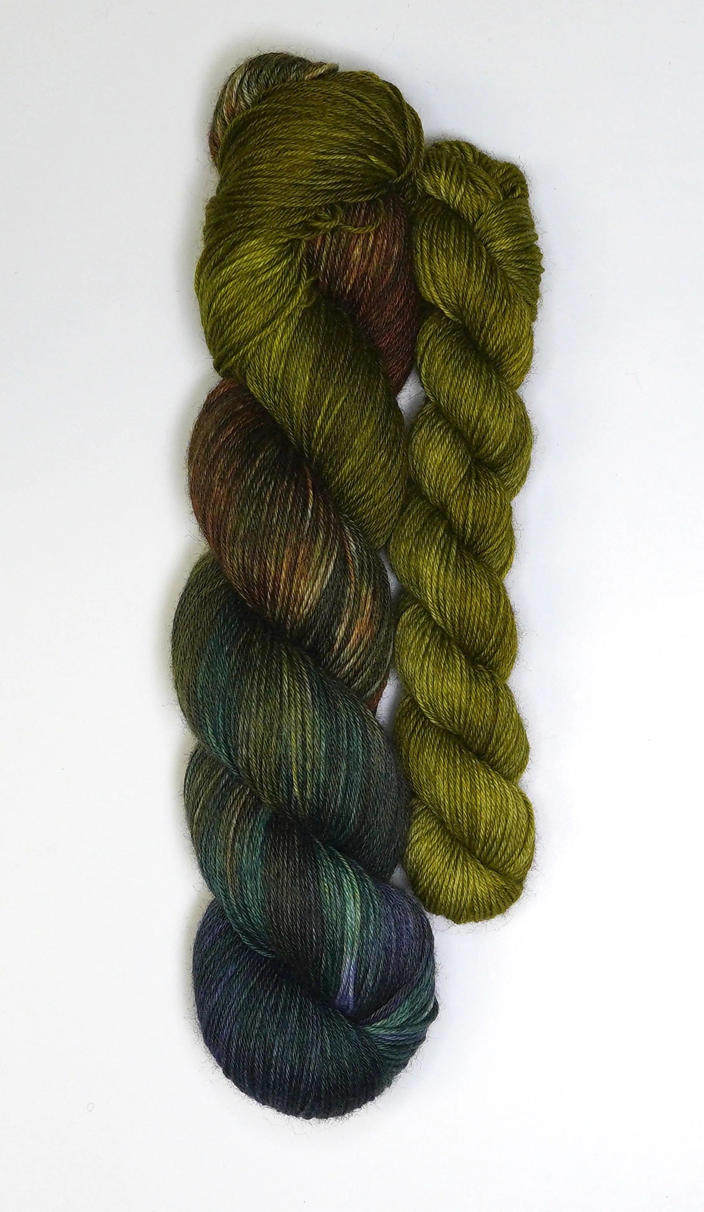 Wild Woollys Mycelium Bloom Fingering Sock Set, two skeins of yarn in green, brown, and dark blue