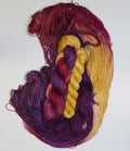 Braided skeins of purple and yellow yarn on a white background