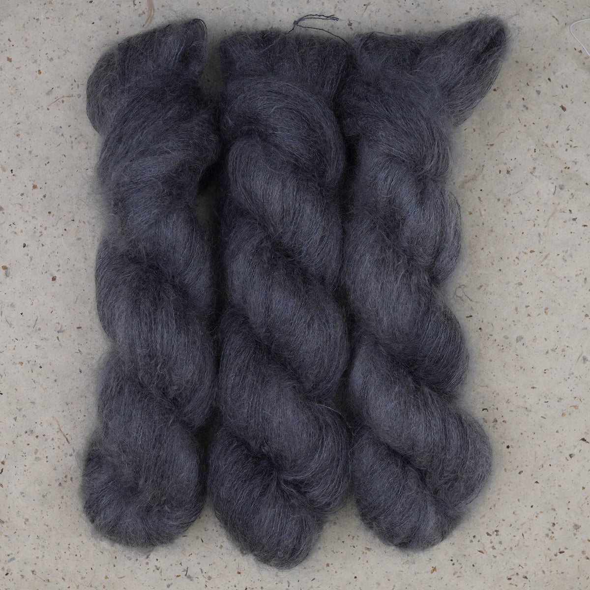 Wild Woollys Obsidian Nights Mohair+Silk yarn, three haloed skeins in deep charcoal grey