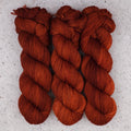Wild Woollys Penny Laine Fingering yarn, three skeins in rich rust orange and copper