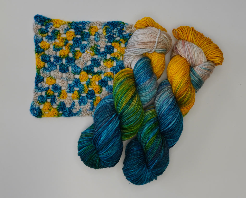 Wild Woollys Tropical Escape yarn with blue, green, yellow, and white colors