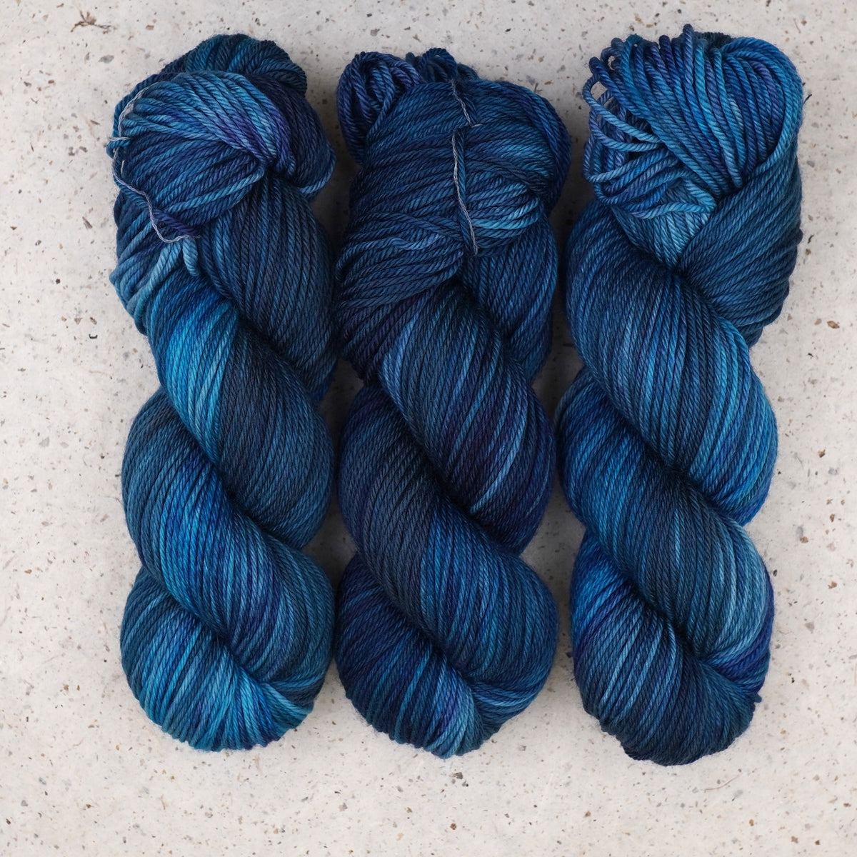 Wild Woollys Teal of Fortune Worsted yarn, three skeins in deep teal and blue