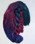 Wild Woollys Winter Aurora Fingering Sock Set with four skeins of yarn in shades of purple, blue, and teal