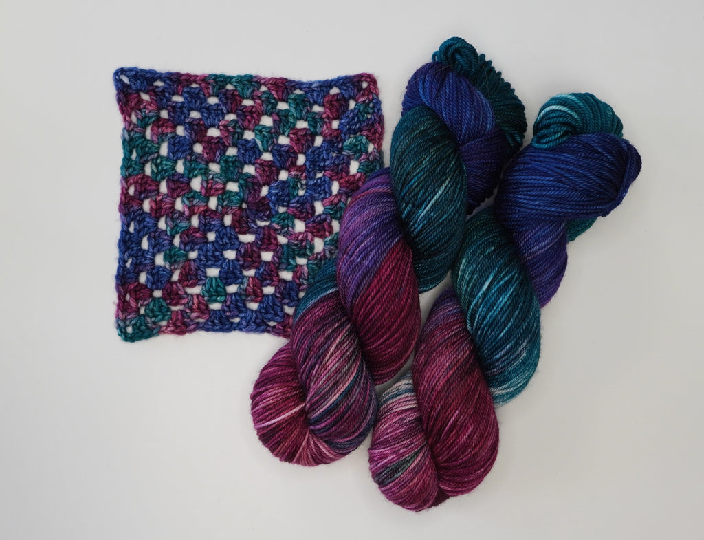Wild Woollys Winter Aurora yarn and crochet swatch in shades of blue, purple, and teal