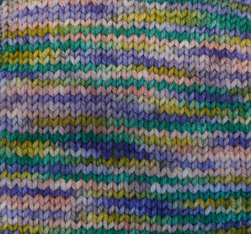 Water Lilies yarn by Wild Woollys, a variegated knit with shades of green, blue, purple, pink, and yellow